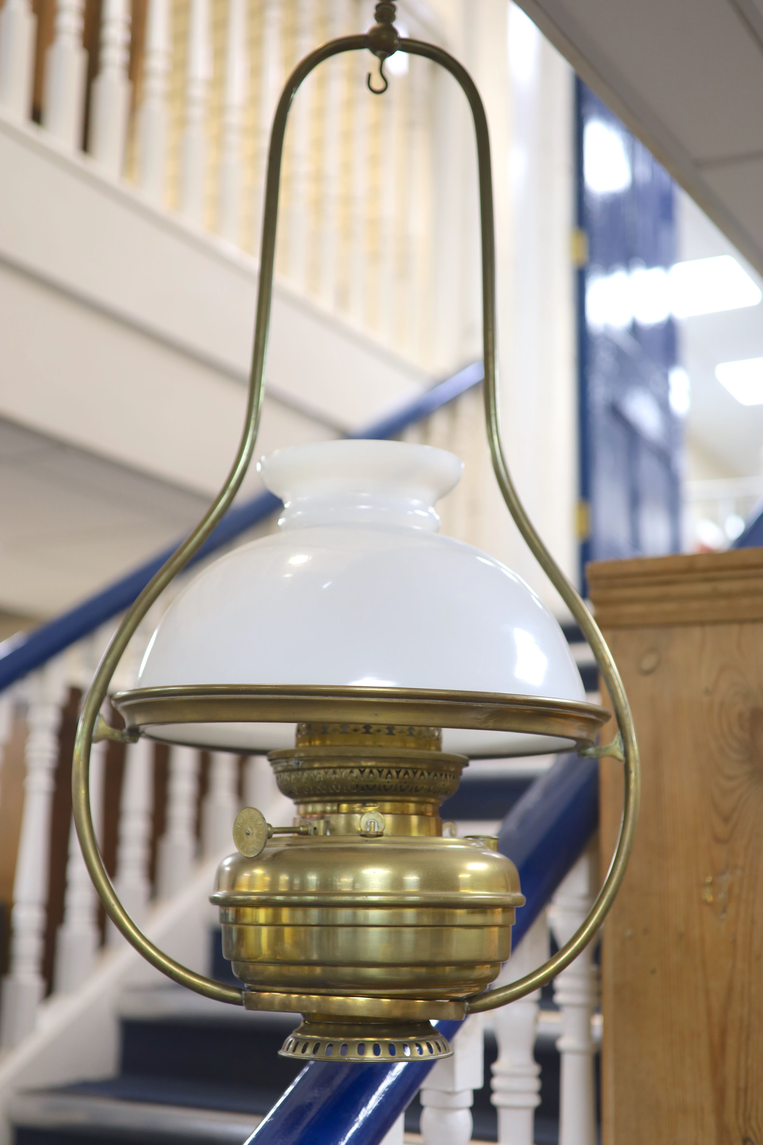 A Victorian brass hanging oil lamp, with a white opaque glass shade, drop 90cm